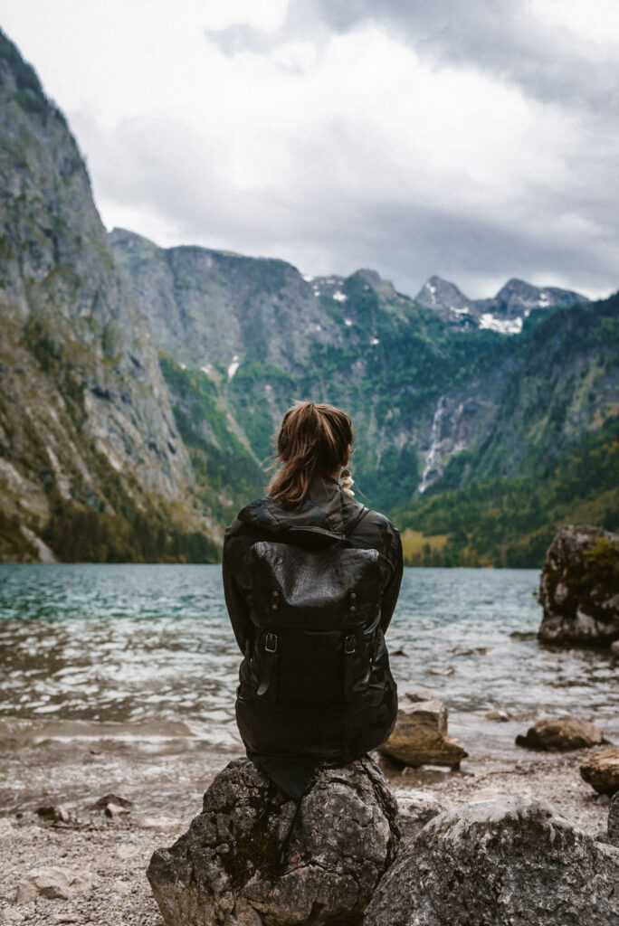 a woman sitting on a rock