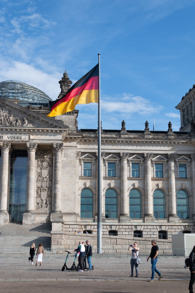 a concrete building with a flag