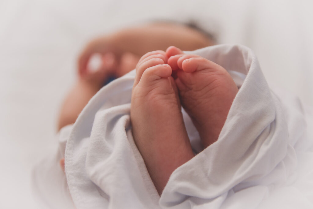 a baby with white blanket